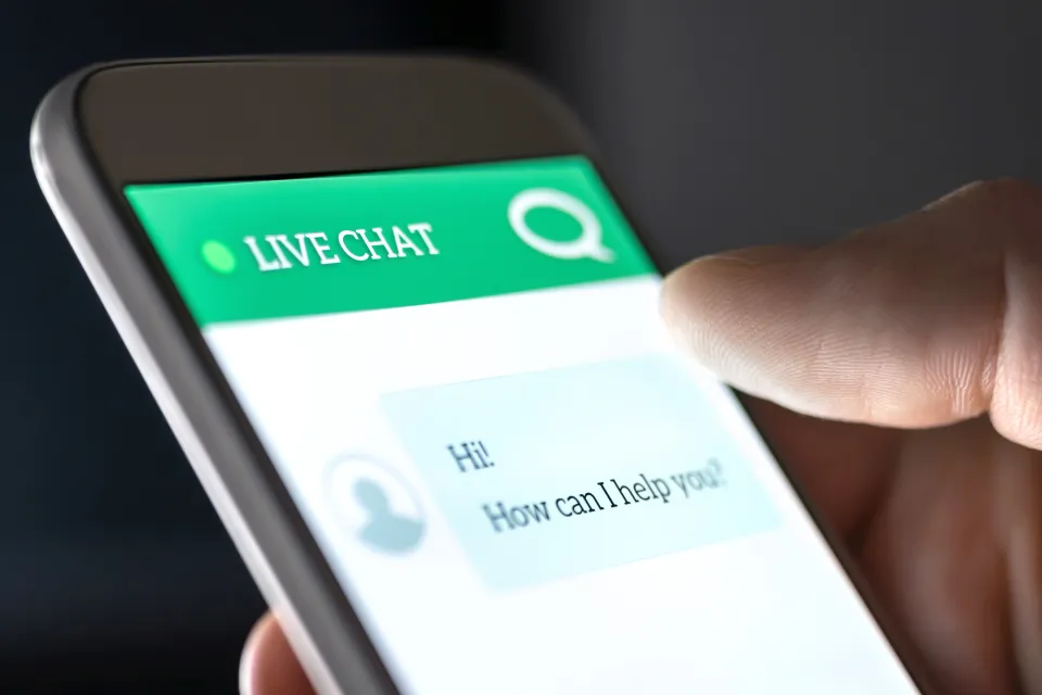 View of a phone with a chatbot interface asking user how it can help them.